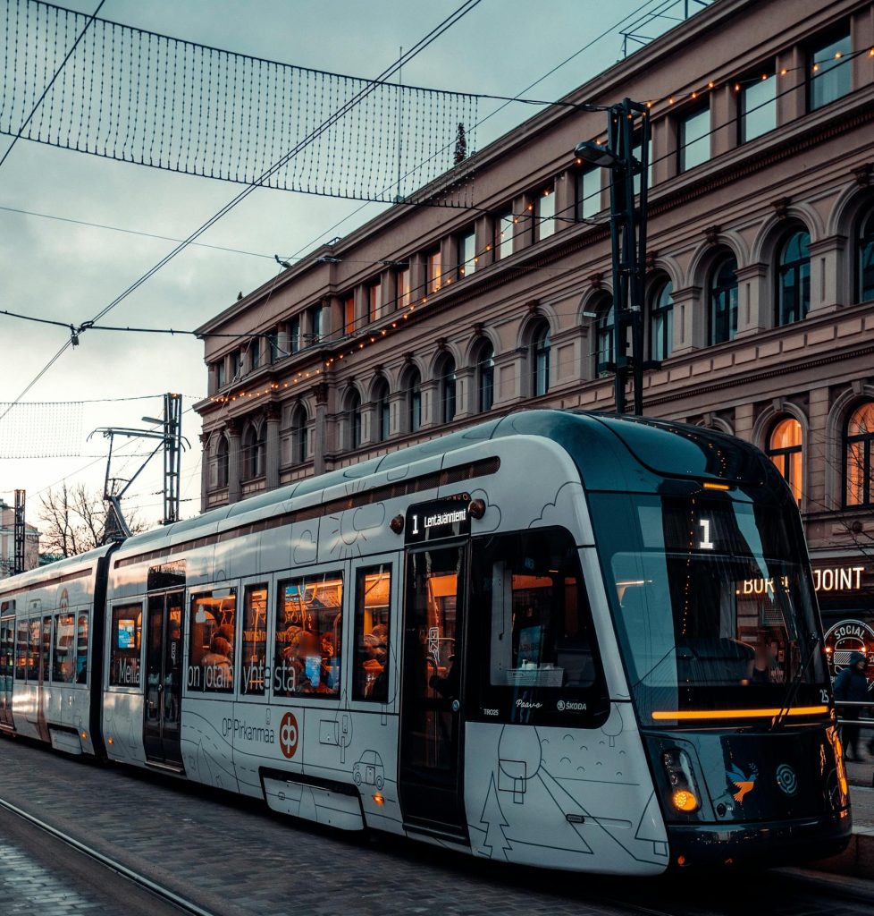 A sleek tram travels through Tampere, Finland, showcasing urban public transportation.